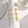 Gold letter charm bracelet displayed to highlight its delicate design and gold-plated finish.
