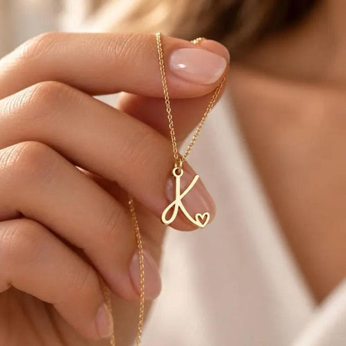 Everlasting Love Necklace delicately held in a woman's hands, showcasing its elegant 18K gold-plated design.
