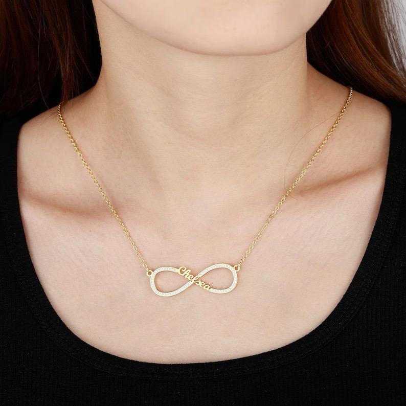 Woman wearing the gold Infinity Love Necklace around her neck.