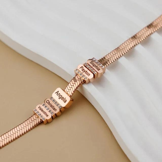 Close-up of the rose gold Forever Family Bracelet showcasing its personalised name charms.

