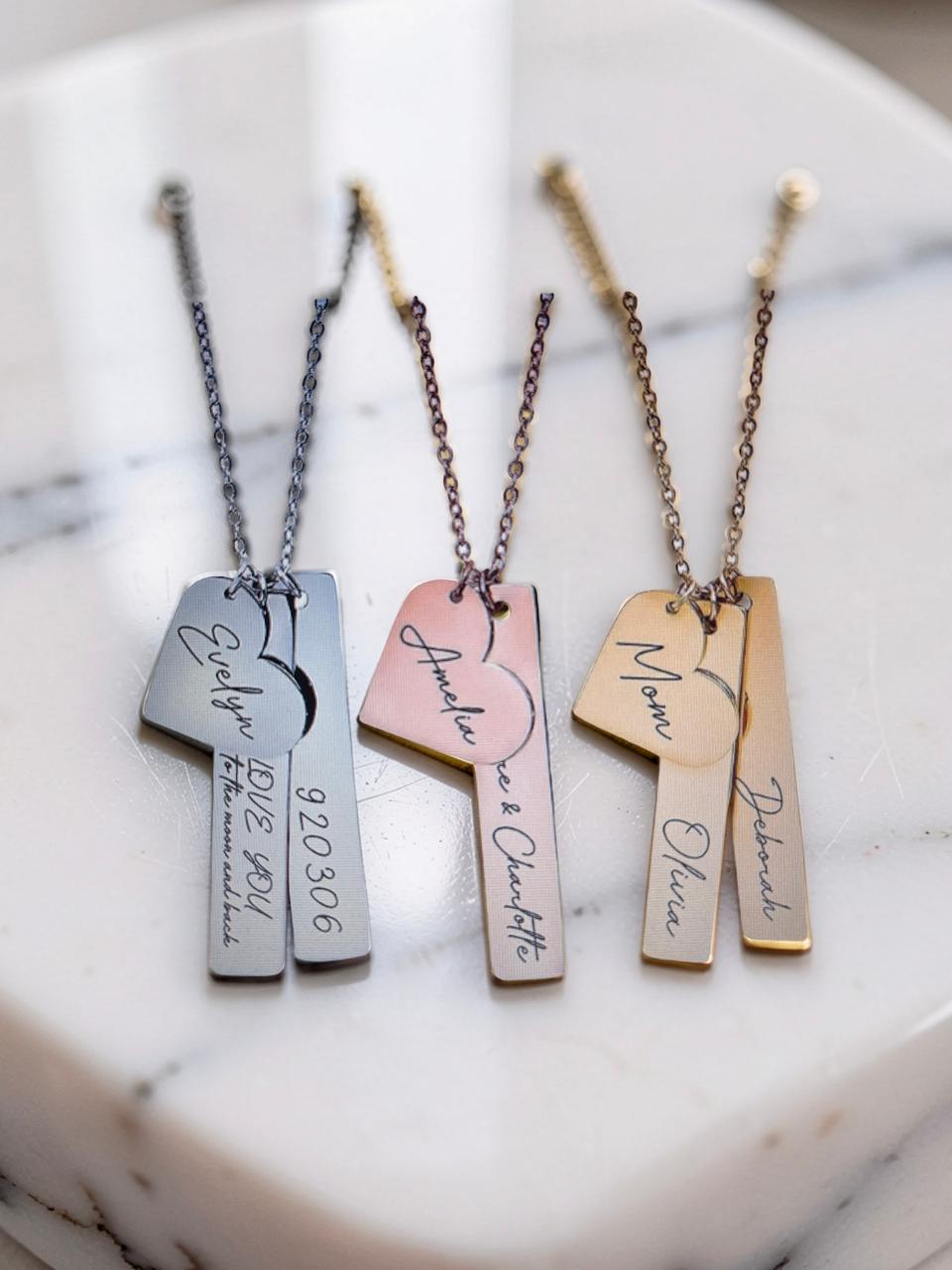 Examples of personalised name and date necklaces featuring different names and birthdates.
