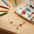 Child’s drawing displayed beside the personalised Little Artist Keepsake Necklace inspired by the artwork.
