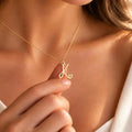 Woman wearing the Everlasting Love Necklace, showcasing its elegant 18K gold-plated design.
