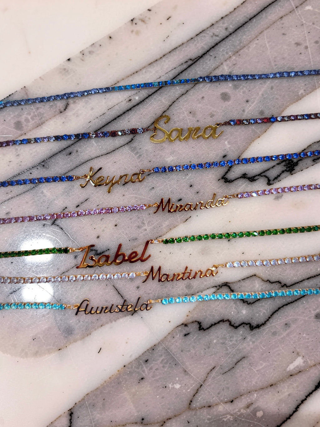 The Tennis Necklace by For KeepSake, displayed in four beautiful colours: Royal Blue, Diamante, Emerald Green and Baby Pink.