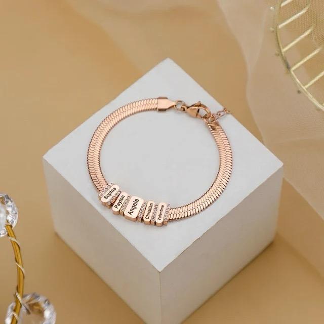 Rose gold Forever Family Bracelet personalised with family names on delicate charms.
